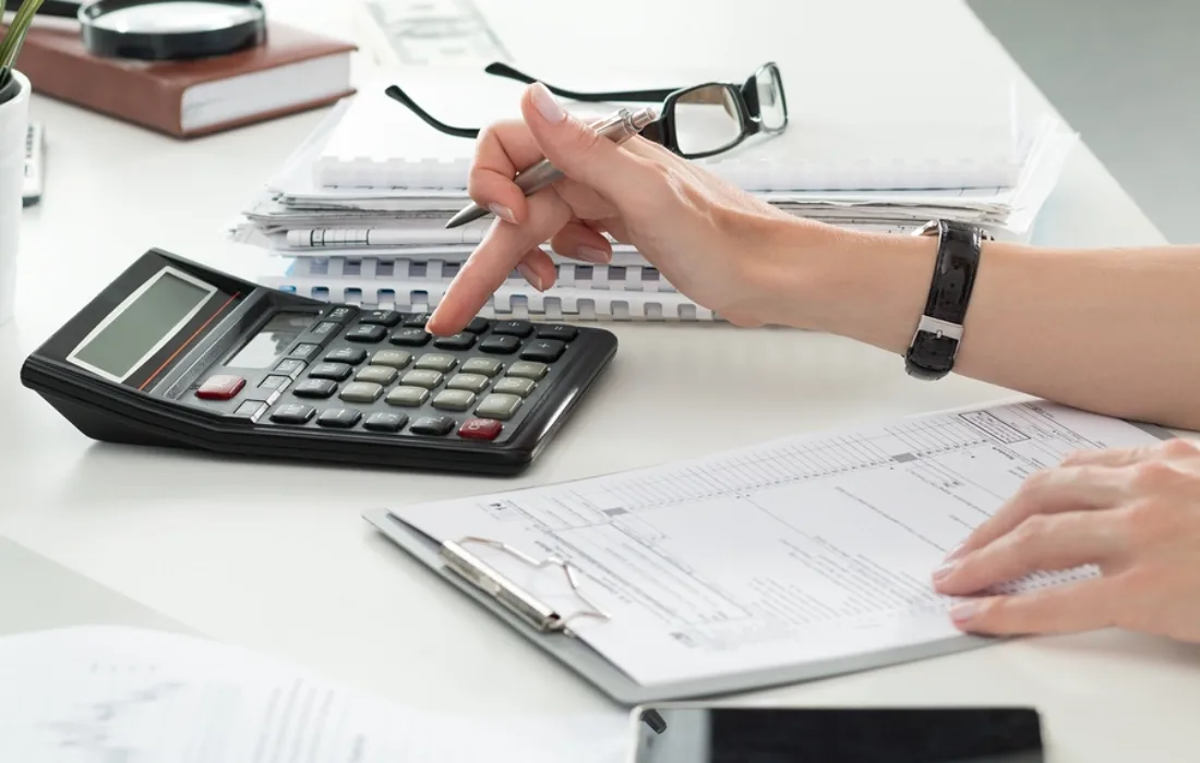 Close up of female accountant or banker making calculations.