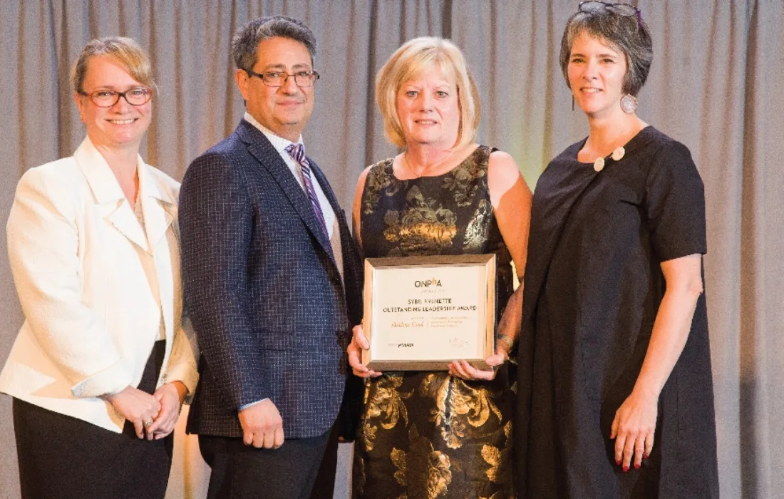 Darlene Cook accepting award on the ONPHA conference