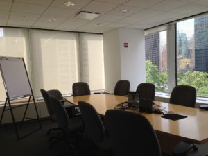 Board room with table, chairs and whiteboard