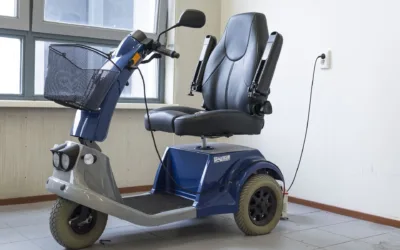 Blue Scooter charging against a wall