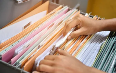 Woman going through files in a filing cabinet