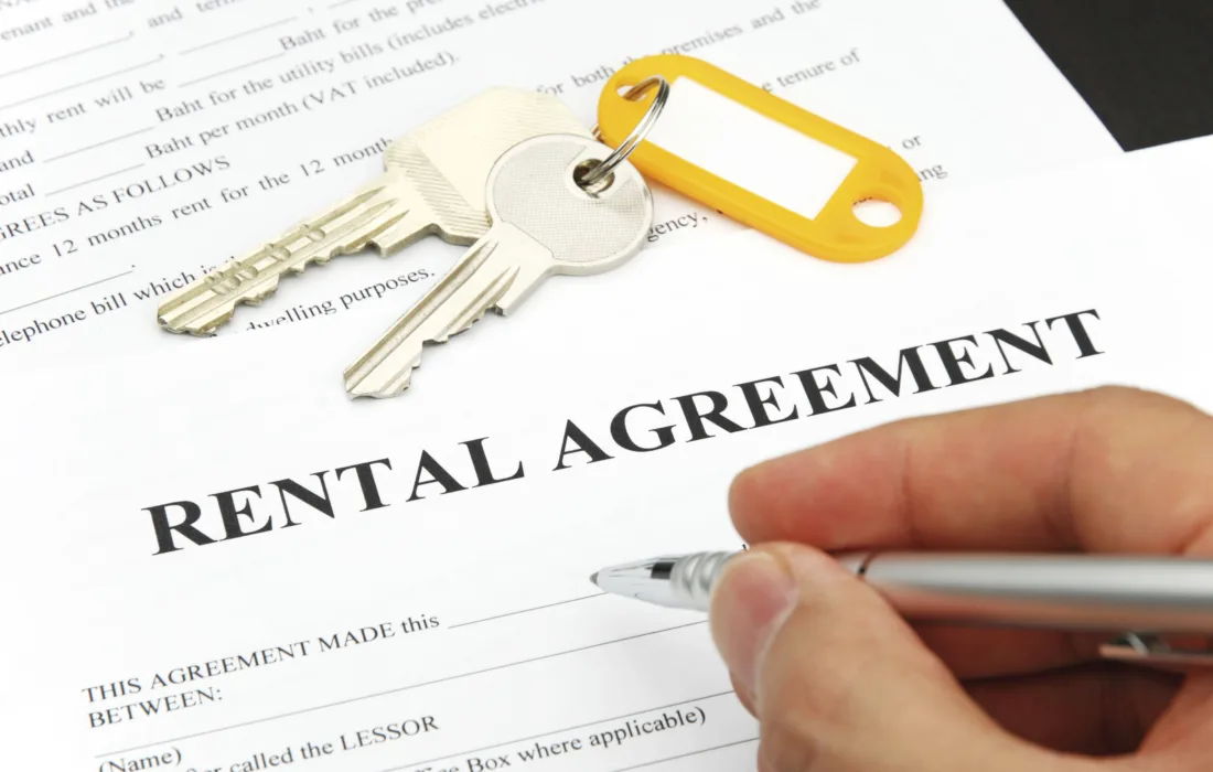 Close up of hand singing rental agreement