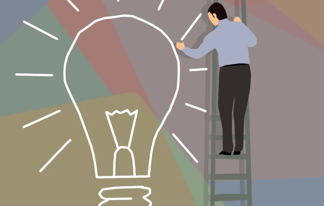 Man on ladder drawing a lightbulb