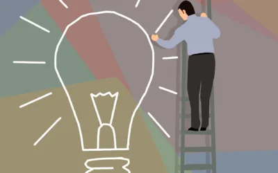 Man on ladder drawing a lightbulb
