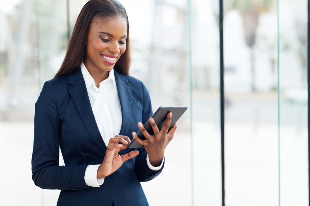 Woman in a business suit holding an ipad