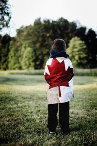 Child wrapped in Canadian flag