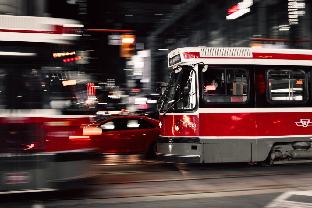Toronto streetcars pass each other at night in the city's downtown core