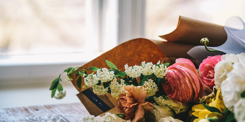 A bouquet of flowers sitting on a windowsill