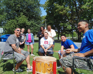 Indigenous people at a community picnic, drummers in the foreground.