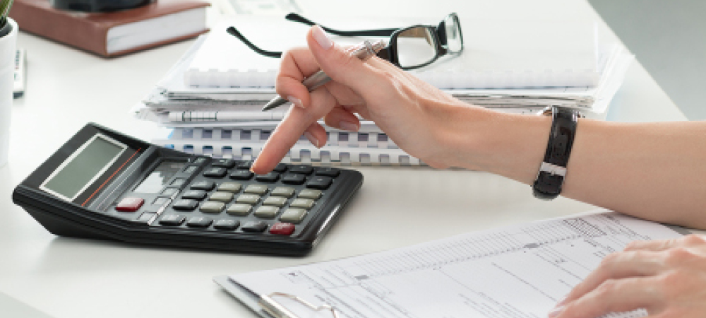 Close up of hands using a calculator