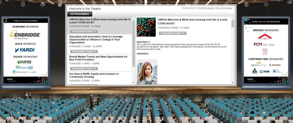 An image of a virtual theatre with screen, stage and people in theatre-style seating