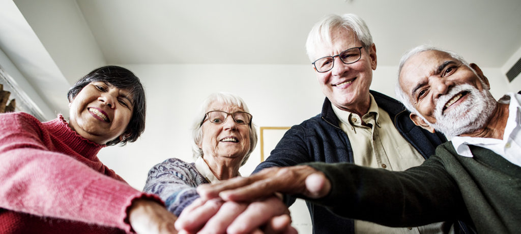 A group of senior citizens gathered together representing teamwork.
