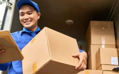 Delivery man holding a box and clipboard