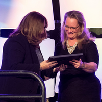 Member receiving an ONPHA Award on stage