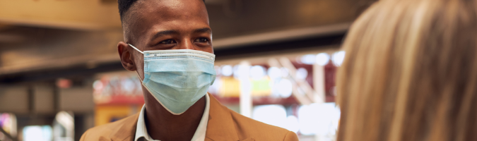 Business professional man wearing a medical face mask
