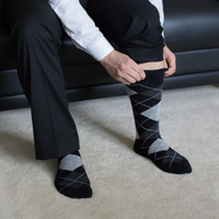 Man putting on argyle socks