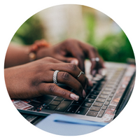 Woman's hands typing on a keyboard