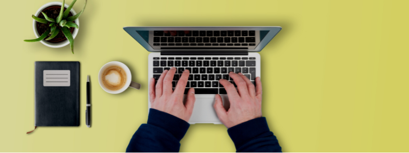Hands typing on a computer