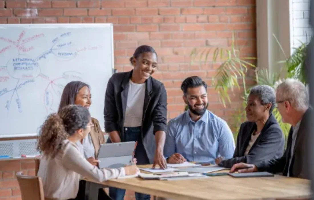 A group of coworkers gathered around a table