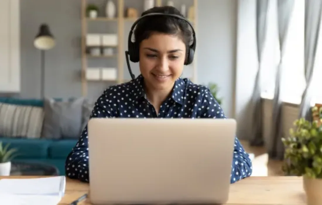 A young person watching a webinar from their laptop