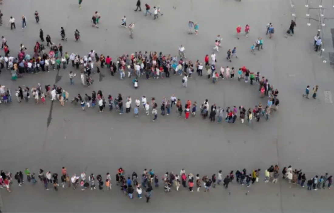 Image of a long line of people waiting for an affordable home