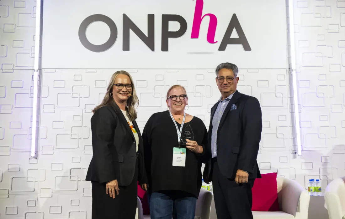 2024 ONPHA Sybil Frenette Outstanding Leadership Award Winner on stage at the ONPHA Conference