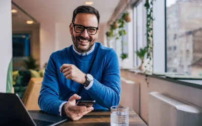 A service manager working on his phone and laptop