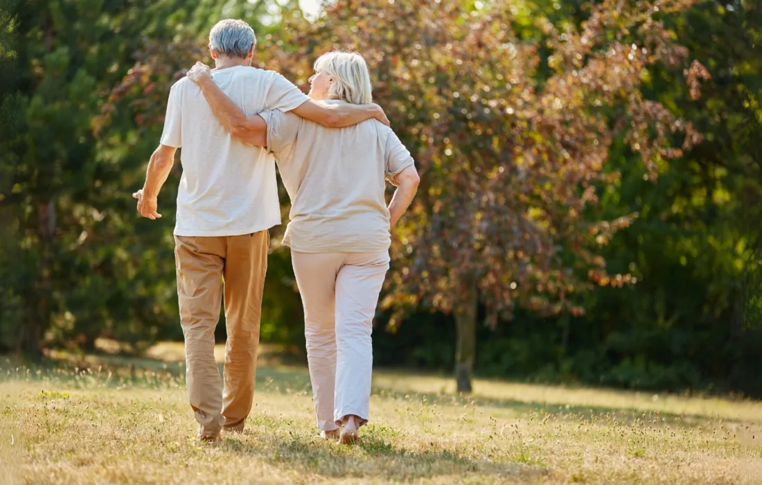 Two seniors walking outside