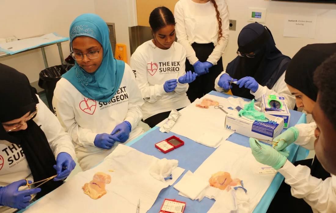A group of students from the Next Surgeon Program dissecting chicken breasts