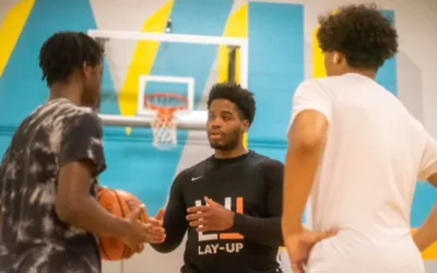 Trevaun Douglas coaching basketball to two youths at Toronto Community Housing