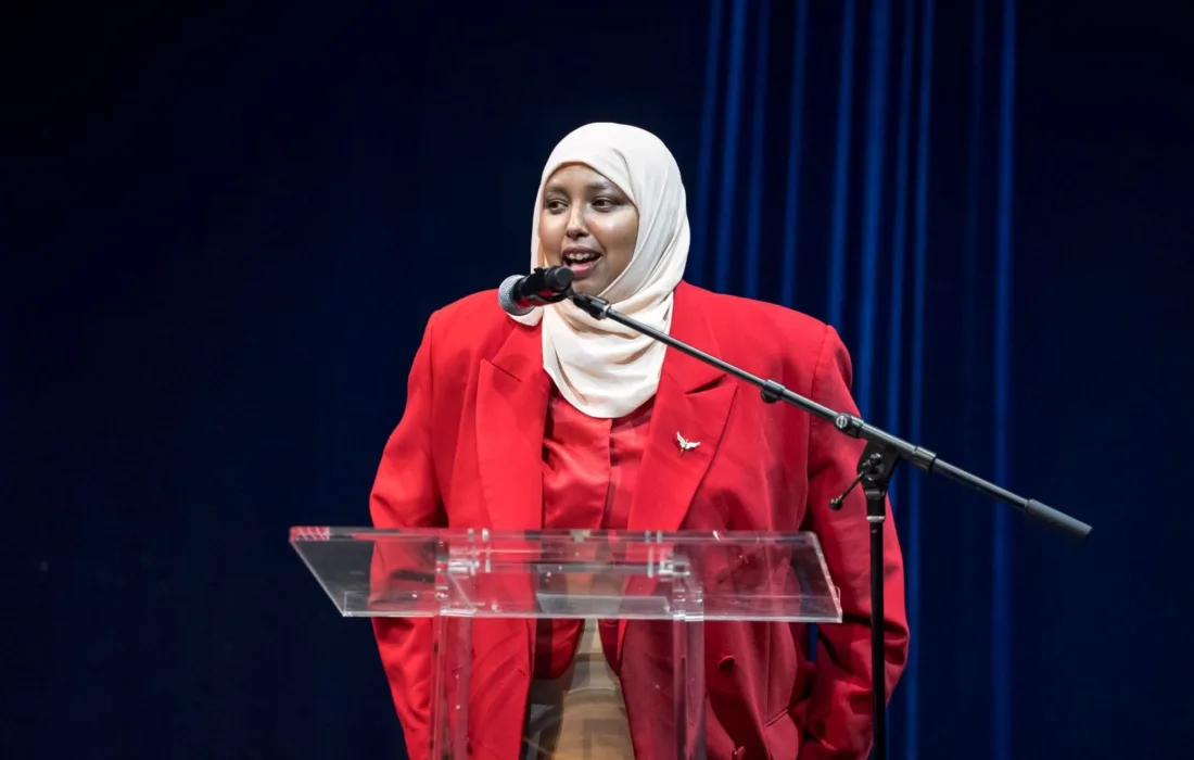 Deqa Nur speaking on stage at the  YWCA Women of Distinction Award ceremony