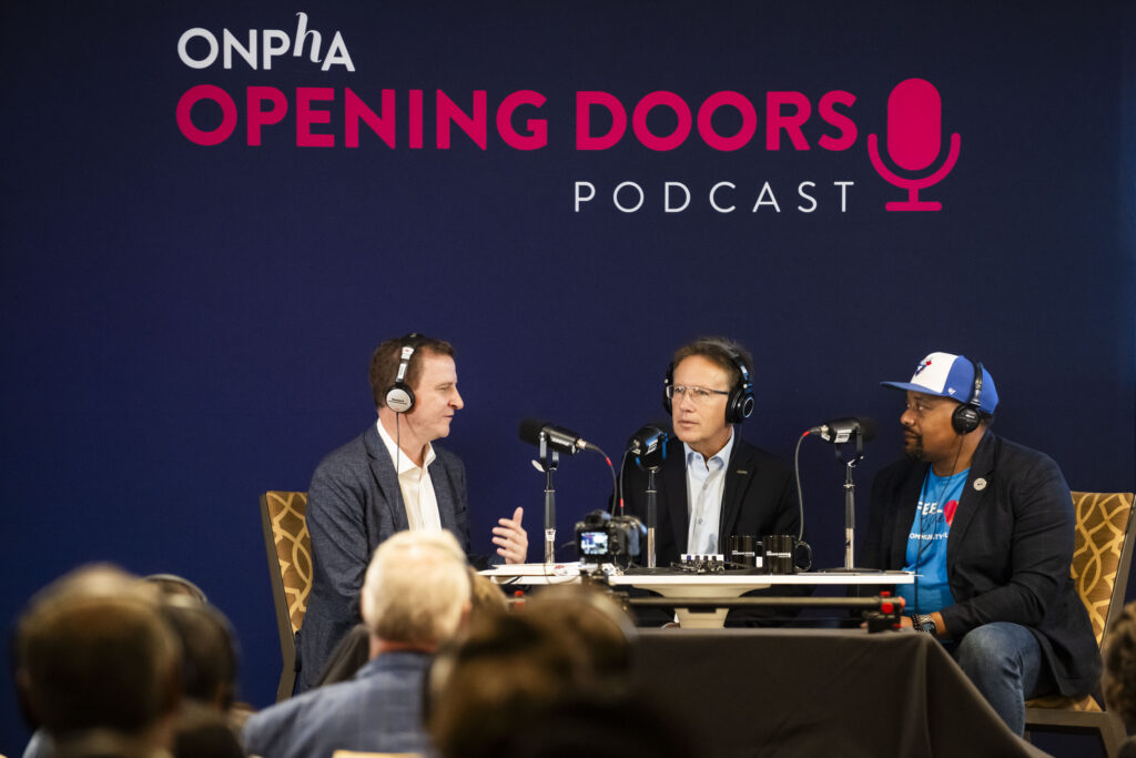 Sean Baird, CEO of Toronto Community Housing Corporation, Stéphane Giguère, CEO of Ottawa Community Housing and Andrew McKenzie of ONPHA, on stage at Season 3 premiere of ONPHA’s Opening Doors Podcast