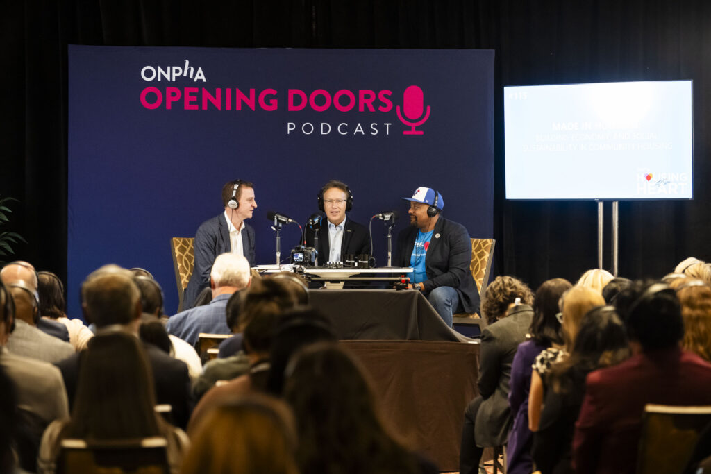 Sean Baird, CEO of Toronto Community Housing Corporation, Stéphane Giguère, CEO of Ottawa Community Housing and Andrew McKenzie of ONPHA, on stage at Season 3 premiere of ONPHA’s Opening Doors Podcast
