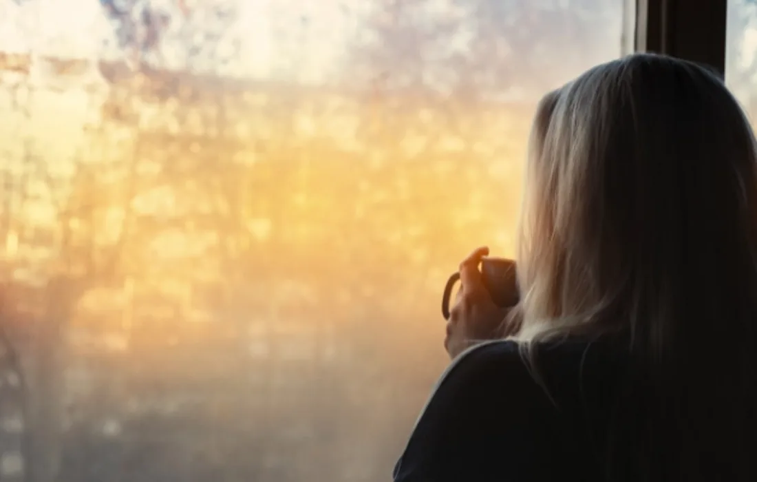 Woman standing by a window
